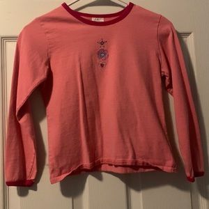 pink long sleeve kids shirt with a blue design in the front.size M 8/10